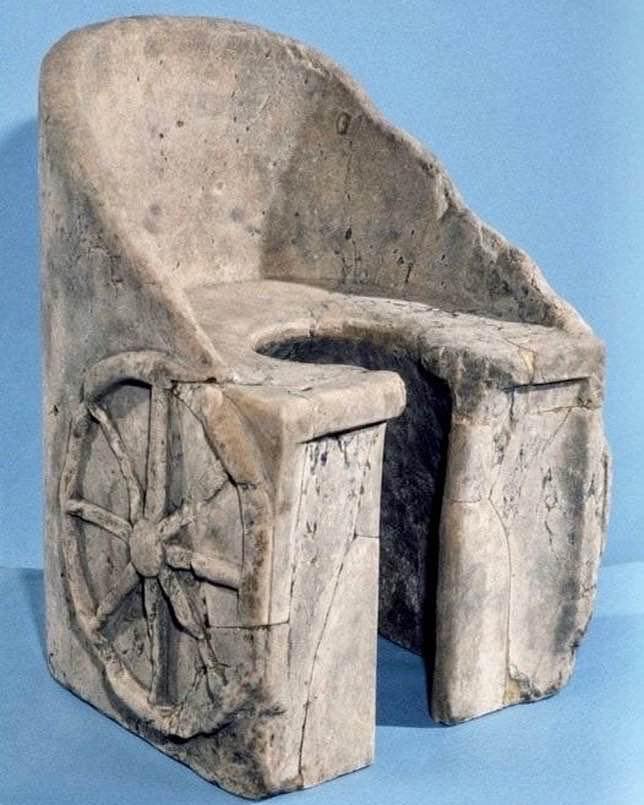 A marble Roman toilet decorated with a cart wheel 211-224 AD